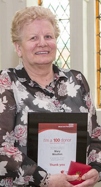 MARY Moulton from Chadderton collects her award and certificate for 100 blood donations