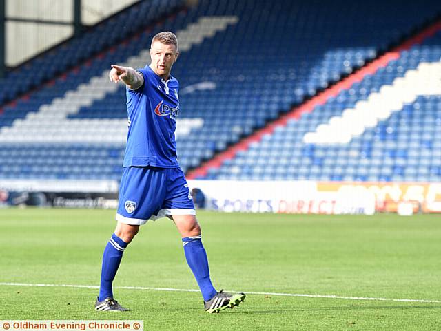 POINTING THE WAY . . . experienced defender Peter Clarke made his Athletic debut last night