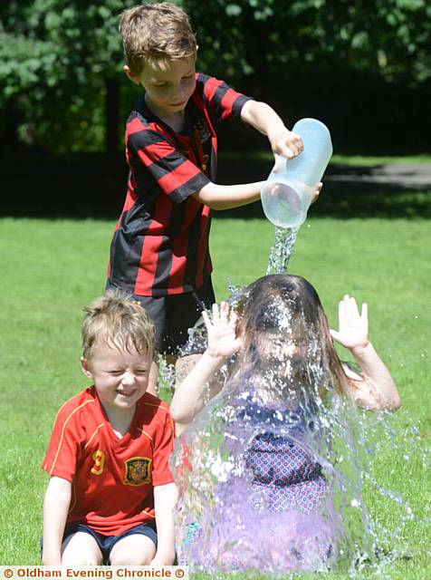 SPLASH . . . Alfie Hibbert and his cousin Niamh Palmer get a shower by Alfie's brother Charlie

