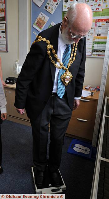 WEIGH in . . . the mayor had to step back off the scales to remove his chains