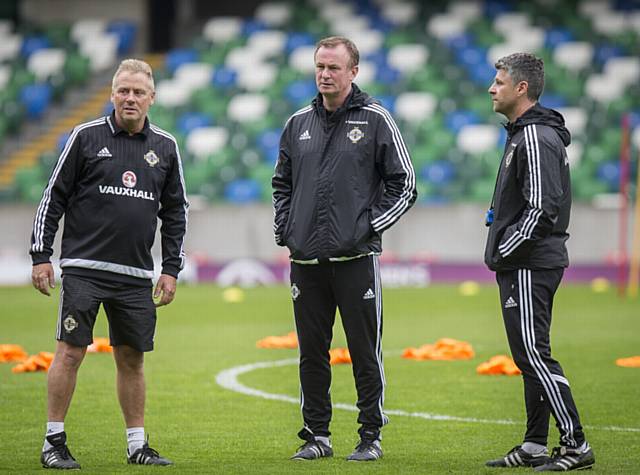 IN THE HOT SEAT? . . . Steve Robinson (right) with Northern Ireland manager Michael O'Neill (centre) and kit manager Colin McGiggert at Windsor Park, Belfast.