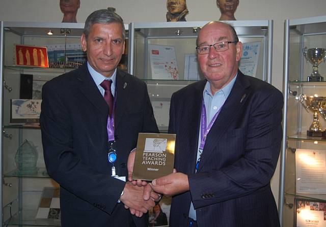 Radclyffe School headteacher Hardial Hayer (left) receives his silver teaching award from chariman of governors Jim Greenwood.
