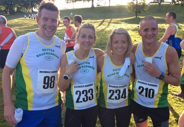 BIG SMILES . . . first two Royton female finishers Jen Bloor (234) and Kirsty White (233) celebrate with fellow team members Lee Higginbottom (98) and Ian Dale (210) at the Rochdale 10k road event
