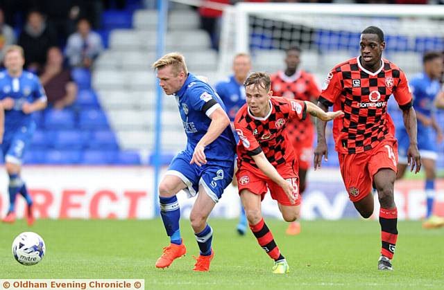 ATHLETIC forward Billy Mckay holds off a Walsall challenge
