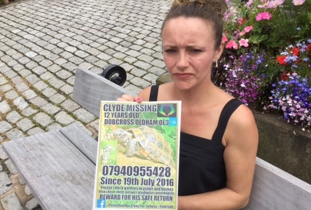 HAYLEY Broxup with her wanted posters for missing tortoise Clyde, who disappeared from Saddleworth a month ago
