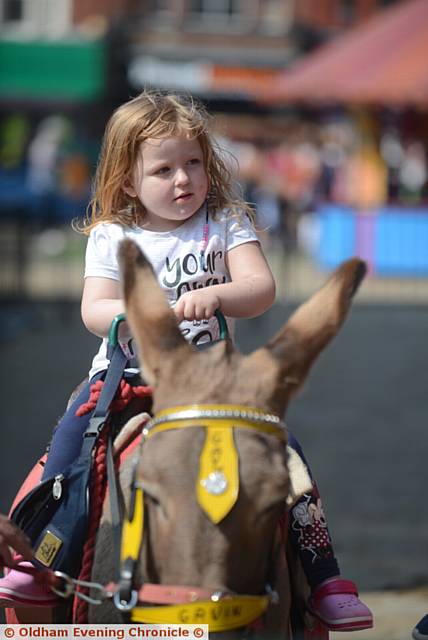 Oldham by the Beach summer festivities in Oldham town centre. Pic shows Mya Stott (3) on Gavin the donkey.