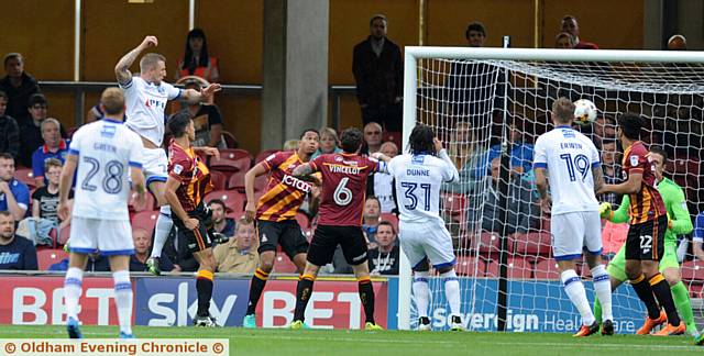 HEAD TURNER . . . Athletic skipper Peter Clarke rises above the Bradford City defence to put his side in front