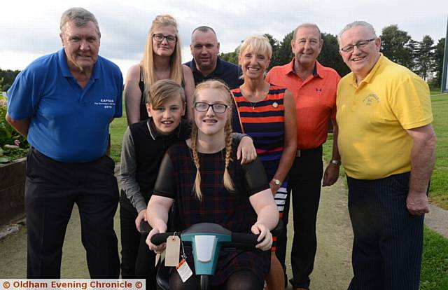 THE Scroungers Golf Society presented a motorised wheelchair to cerebral palsy sufferer Raygan Cornwell (15), from Bolton, at Crompton and Royton Golf Club. Raygan is pictured with her brother Rhys Cornwell (12) in foreground with,from the left, David Parkinson (Scroungers captain), Lyndsay Cornwell (Raygan’s mother), David Cornwell (Raygan’s
father), Linda Haughton (C&R lady captain), Syd Barton (Scroungers charity rep) and Keith Berriman (Scroungers president).
