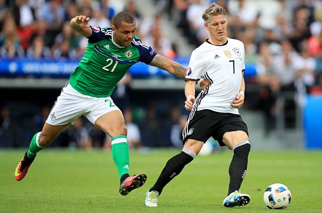 NORTHERN Ireland's Josh Magennis (left) and Germany's Bastian Schweinsteiger battle for the ball during the UEFA Euro 2016. Athletic's hopes of signing Magennis appear to be diminishing