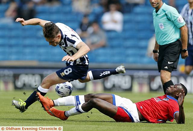 ON THE SLIDE . . . Ousmane Fane tackles Ben Thompson as Athletic were beaten 3-0 at Millwall.