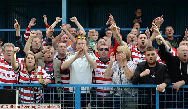 THE ONLY WAY IS UP . . . Oldham's fans celebrate avoiding the drop