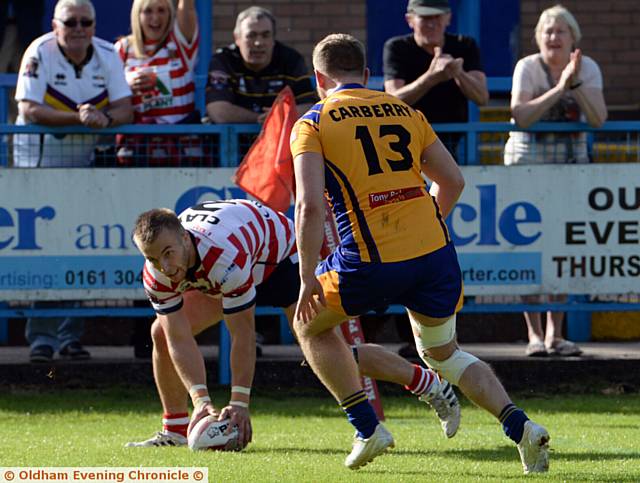 TRY . . . Adam Clay touches down over the whitewash for Roughyeds