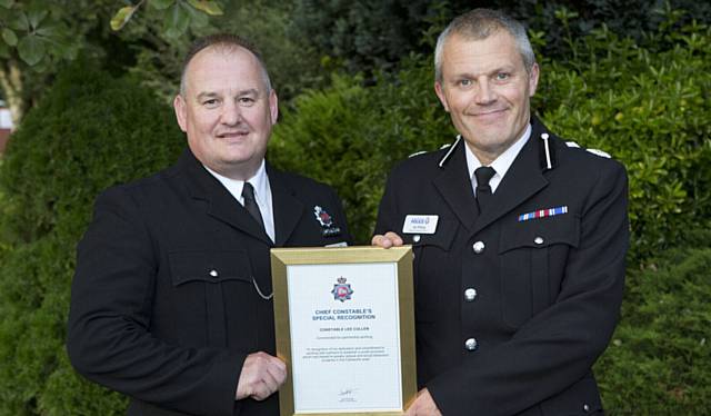 PC LEE Cullen, left, receives his police commendation from DCC Ian Pilling