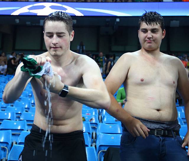 WET THROUGH . . . a Borussia fan wrings out his shirt