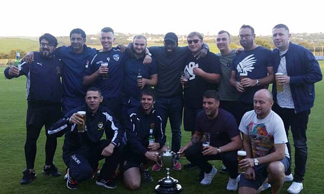 MINE'S A PINT . . . Heyside players and officials raise a glass or two to their title triumph in the Pennine Cricket League