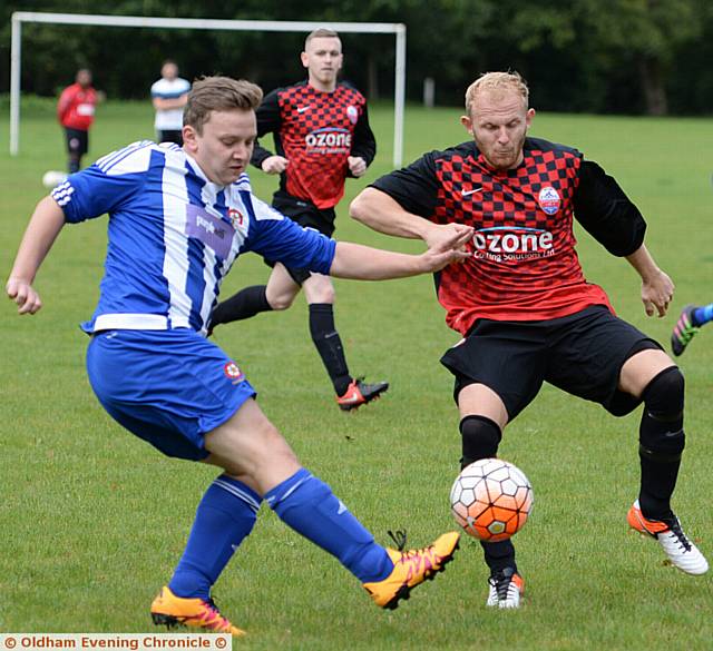 GET STUCK IN . . . Diggle's Jason Owens (left) makes a clearance against Newsome