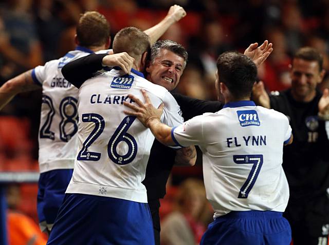 GET IN . . . Peter Clarke (No. 26) gets a hug from manager Stephen Robinson after scoring Athletic's equaliser against Charlton at The Valley last night