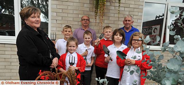 PRIDE in Oldham nomination for Rushcroft Primary School garden club team. Glynnis Queenan, Eddie Costello and Will Queenan with children, from left, Connah Brown, Brooke Lamb, Luke Blackburn, Elliot Eastham, Tristan Ross and Jenna Ladkin