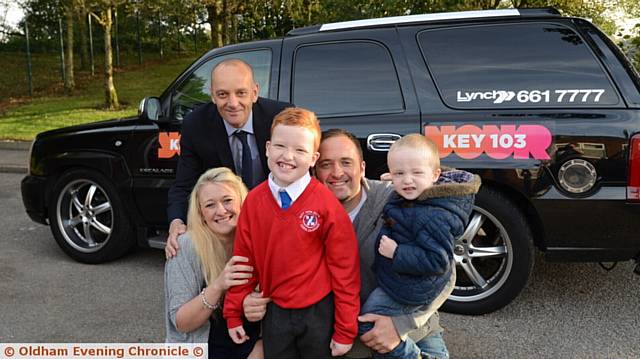 ARRIVING in style . . . Liam Kearney with head teacher Andrew Clowes (left), his mum Felicity, dad Daniel and little brother Charlie