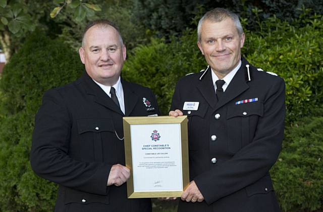 PROUD moment . . . PC Lee Cullen, left, gets his commendation from DCC Ian Pilling