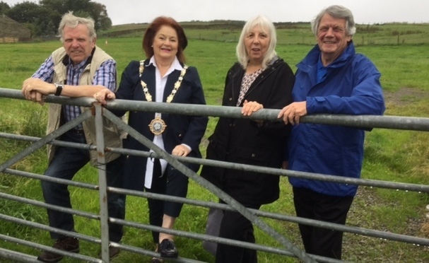 ALL SMILES: Left to right, Councillor Robert Knotts, Councillor Pam Byrne, chair of Saddleworth parish council, Joan Sykes, chair of Scouthead and Austerlands Community Group, and David Needham, secretary of the Scouthead and Austerlands Whit Friday Brass Band Contest Committee
