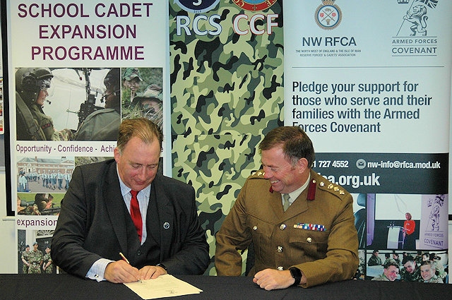 Headteacher Neil Hutchinson with Colonel Phil Harrison as they sign the Armed Forces Covenant for Royton and Crompton School