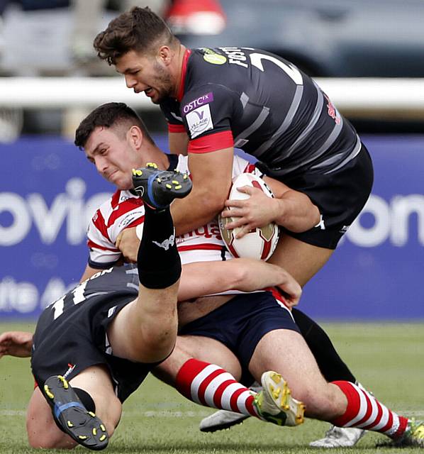 Liam Thompson of Oldham is held during the Kingstone Press Championship game