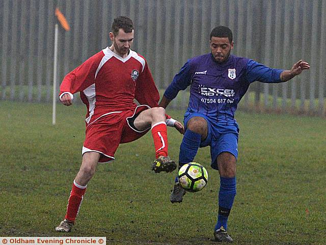 EYES DOWN . . . Springhead Libs’ Ben Cullen (left) and
Crown’s Danny Browne challenge for the ball
