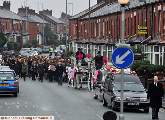 MOURNERS gather behind horse-drawn carriages on Copsterhill Road yesterday
