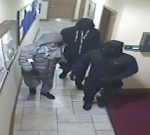 A CCTV still from Chadderton Cricket and Bowling Club shows the three armed men
