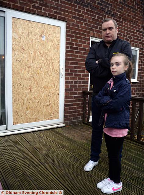 LEE Kinghorn and daughter Evie outside their shattered patio window.