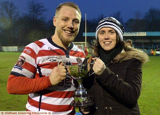 ALL YOURS...Scott Leatherbarrow receives the Oldham Rugby League Heritage Trust trophy from Jenny Turner