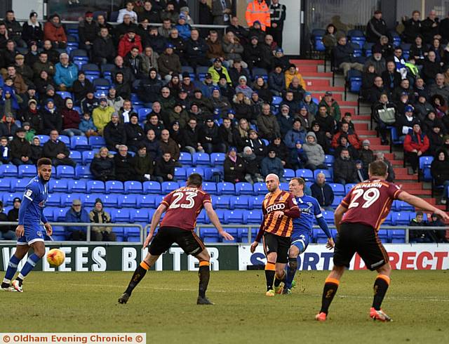 IT'S THERE . . . Brian Wilson (slightly obscured) scores what turned out to be Latics' consolation goal against Bradford.