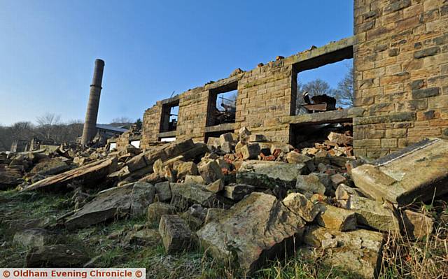 GHOSTLY . . . Bailey Mill in Delph is still half demolished after a fire destroyed it last year.