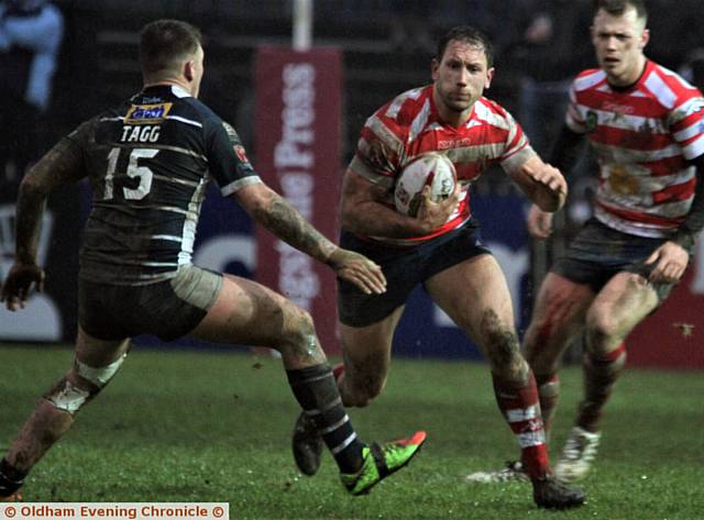 POWERFUL . . . Oldham's Adam Neal drives forward toward a Featherstone tackler

