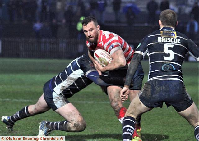 BREAKING THROUGH . . . Oldham centre Danny Grimshaw does his best to evade a Featherstone tackle
