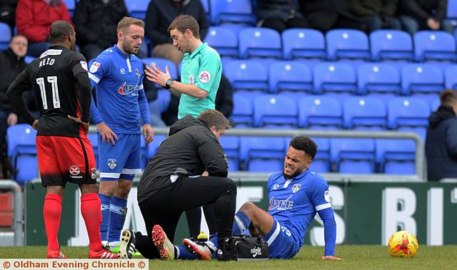 GROUNDED . . . Aaron Amadi-Holloway gets treatment before going off after 19 minutes against Coventry City