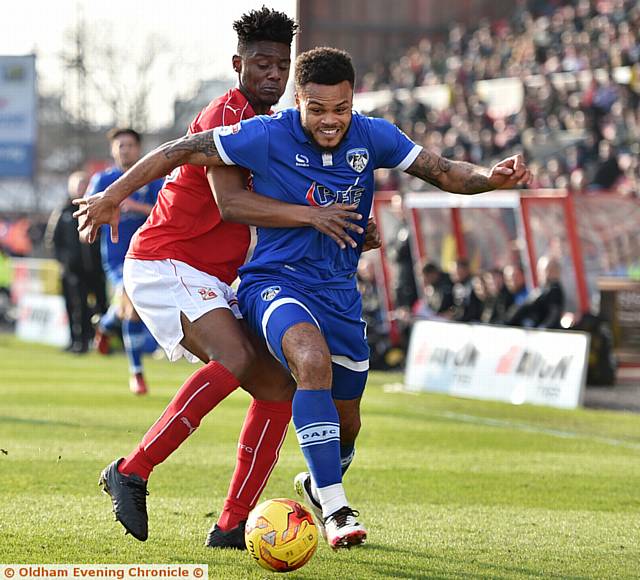 FACE OF DETERMINATION . . . Athletic striker Aaron Amadi-Holloway tries to get away from his man