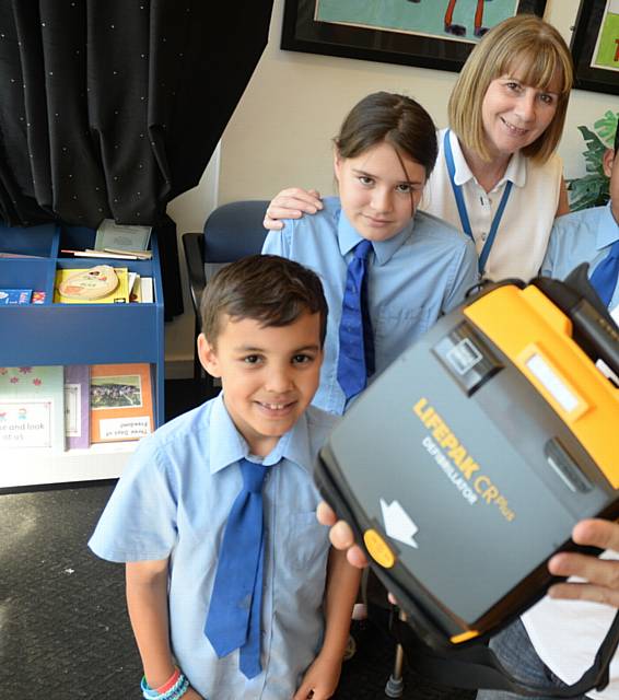 Hand on Heart supplied a defibrillator for Holy Rosary RC Primary School in 2015 thanks to fundraiser Paul Moss. L-R Ethan Moss (9), Elysia Kay - Davies (10), head teacher Barbara Morris and Hamza Ishtiaq (11).