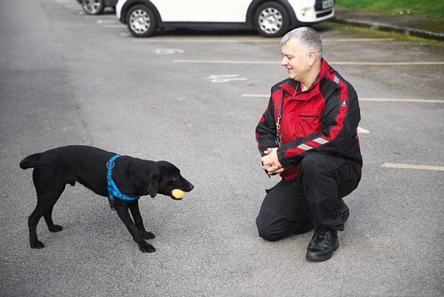 New recruit Eric (17 months) with Greater Manchester Fire and Rescue Service Dog Unit Manager Mike Dewar.