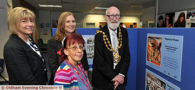PEACE pledge signing at Oldham Sixth Form College, from left, principal Jayne Clarke, Emma Hart, OSFC assistant director for inclusion, and the Mayor, Councillor Derek Heffernan. Front is Maria Ellis, chairman of Peace Talks Oldham