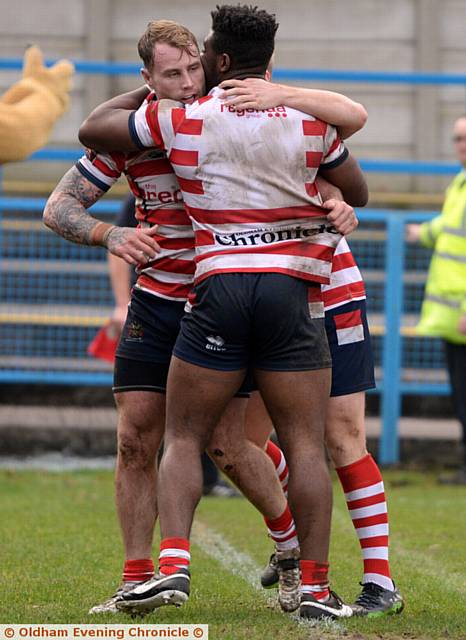 UP AND RUNNING: Danny Langtree gets a hug after scoring Oldham's opening try