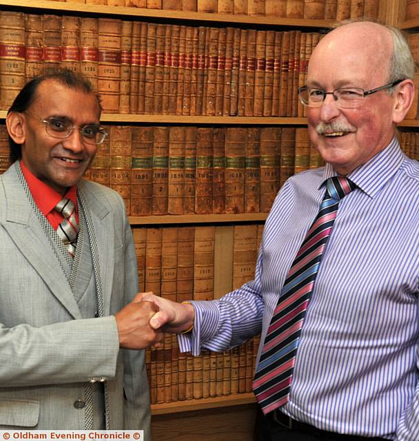 PARTNER Godfrey Pickles (right) who retires from Wrigley Claydon solicitors, with Vijay Srivastava who is taking over