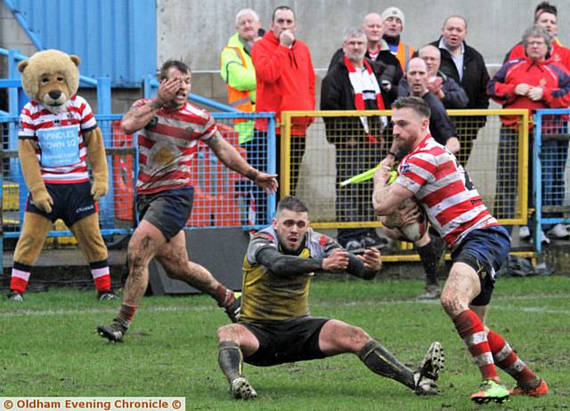 GET AWAY . . . Danny Grimshaw dumps his Haydock opponent to the ground on his way in to score 