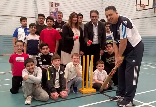 HOWZAT . . . Coach John Abrahams with pupils and Medlock Vale councillors (centre) Yasmin Toor and Ateeque Ur-Rehman at Hathershaw College cricket academy