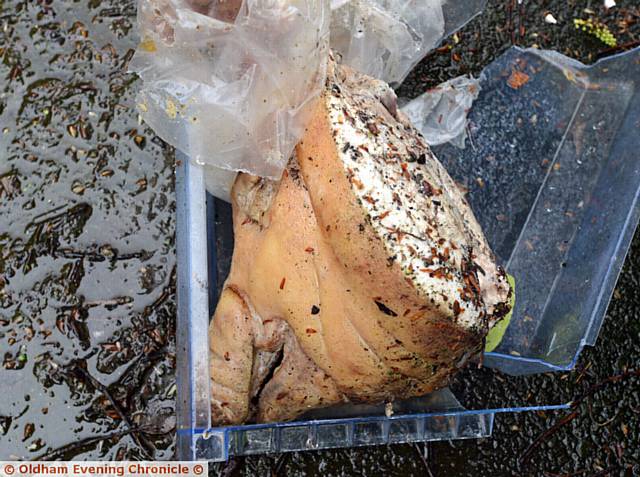 DISGUSTING . . . the pig's head found among rubbish in a locked alley in Hathershaw