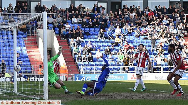 GET IN THERE . . . Tope Obadeyi slides in to score Latics' first-half goal