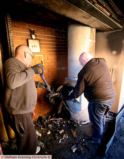 CHARRED rubbish is removed from the scene of the fire