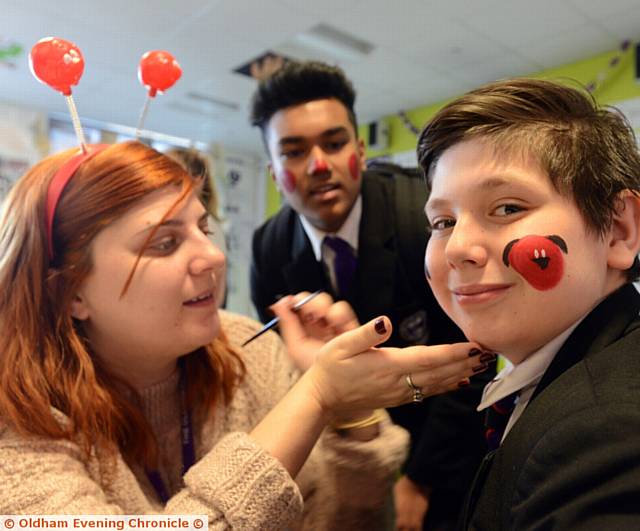 FACE-PAINTING . . . Teacher Lonya Burns with pupils Jahan Uddin (left) and Alex Pokuta at Red Nose Day at the Oldham Academy North