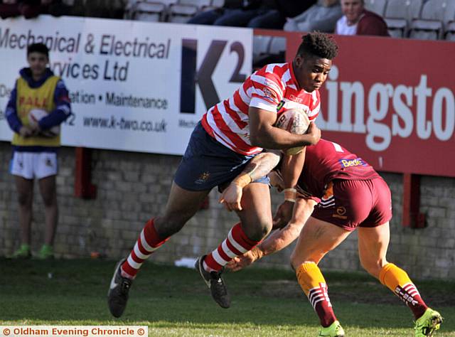 INTO CONTACT . . . Centre Tuoyo Egodo is tackled low by a Bulldogs defender